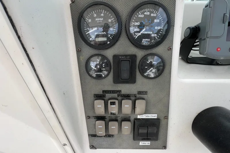 Slide: The Image of Control panel of a 2006 Striper 2301 Walkaround OB boat with gauges and switches. - 20