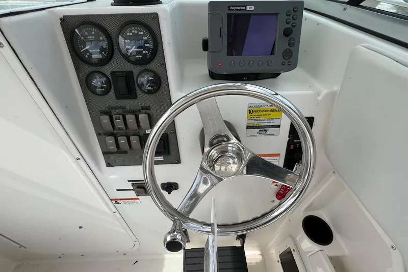 Slide: The Image of 2006 Striper 2301 Walkaround OB dashboard with steering wheel and navigation instruments. - 21