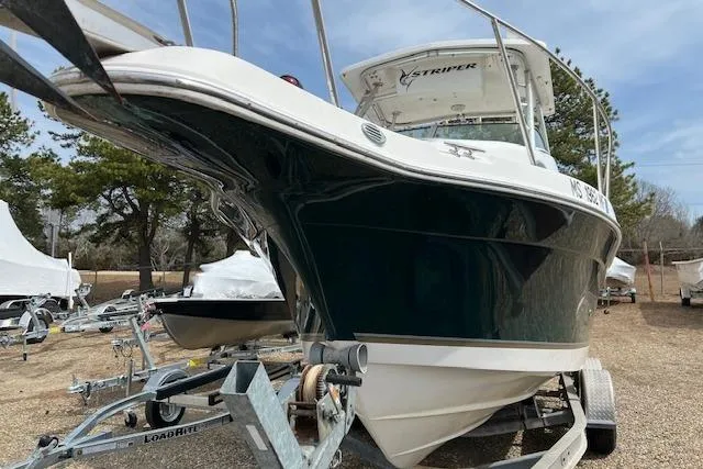 Slide: The Image of 2006 Striper 2301 Walkaround OB boat on trailer, parked outdoors. - 28