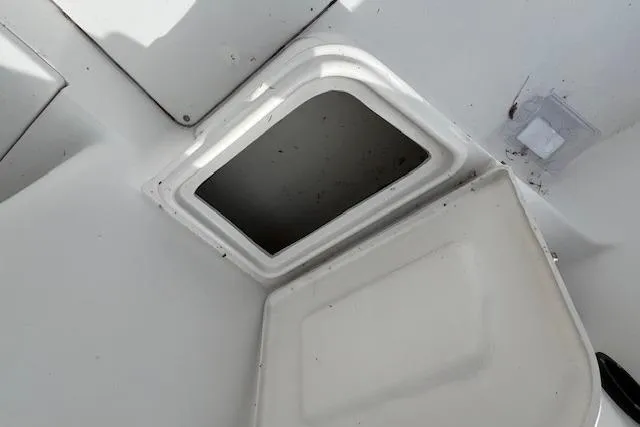 Slide: The Image of Open storage compartment on 2006 Striper 2301 Walkaround OB boat. - 33