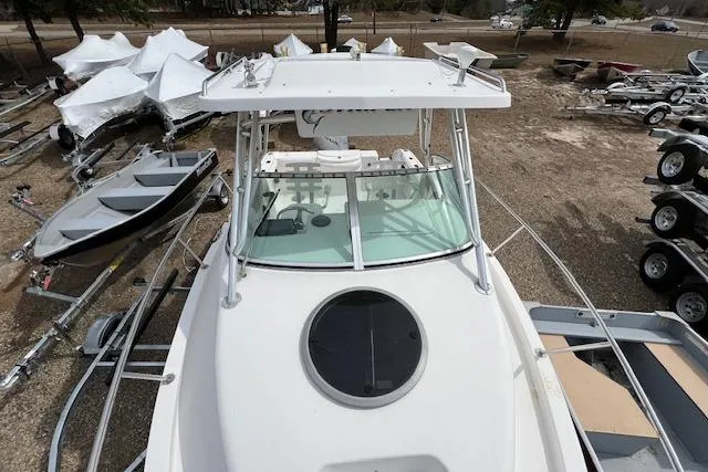 Slide: The Image of 2006 Striper 2301 Walkaround OB boat on trailer, surrounded by other boats. - 6