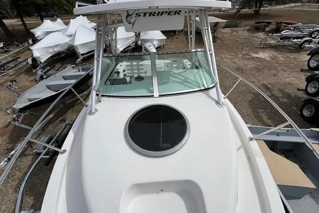 Slide: The Image of 2006 Striper 2301 Walkaround OB boat, top view, docked with trailers nearby. - 7