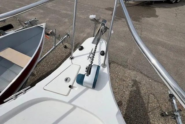Slide: The Image of 2006 Striper 2301 Walkaround OB boat bow with anchor chain and railing. - 8