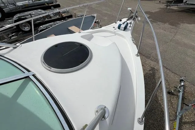 Slide: The Image of 2006 Striper 2301 Walkaround OB boat deck with hatch and railing. - 9