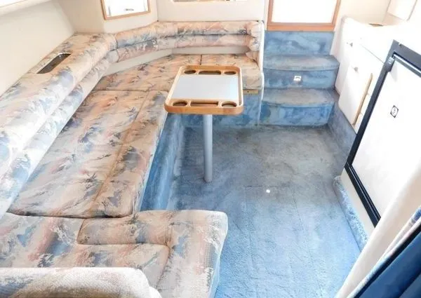 Slide: The Image of Interior of a 1995 Sea Ray 330 Express Cruiser with blue upholstery. - 11