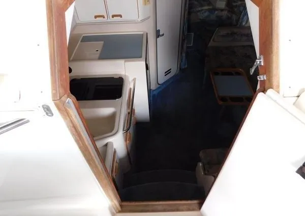 Slide: The Image of Interior of 1995 Sea Ray 330 Express Cruiser, featuring kitchen and seating area. - 12