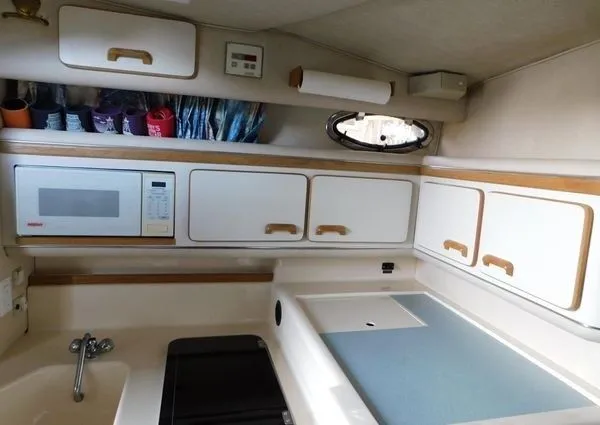 Slide: The Image of Interior of 1995 Sea Ray 330 Express Cruiser with kitchen and storage. - 15