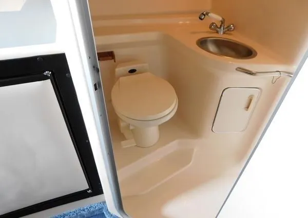 Slide: The Image of 1995 Sea Ray 330 Express Cruiser bathroom with toilet and sink. - 18