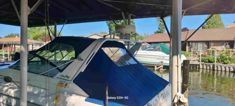 Slide: The Image of 1995 Sea Ray 330 Express Cruiser docked on a sunny day. - 2