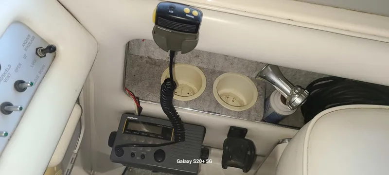 Slide: The Image of Interior of 1995 Sea Ray 330 Express Cruiser with radio and controls. - 20