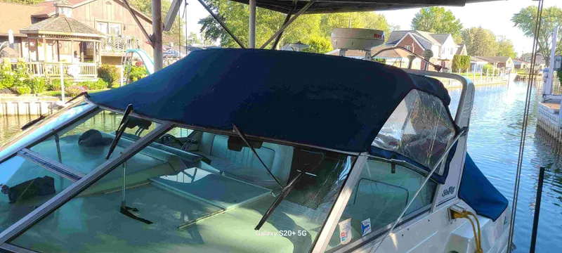 Slide: The Image of 1995 Sea Ray 330 Express Cruiser docked with cover. - 4