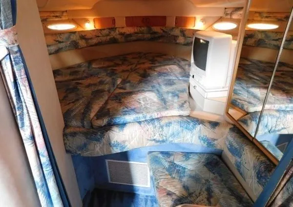 Slide: The Image of Interior of 1995 Sea Ray 330 Express Cruiser with cozy bed and TV. - 7