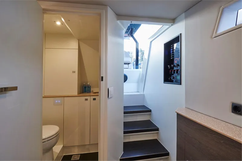 Slide: The Image of Interior of 2019 Chaser 500R yacht, featuring a modern bathroom and stairway to deck. - 6