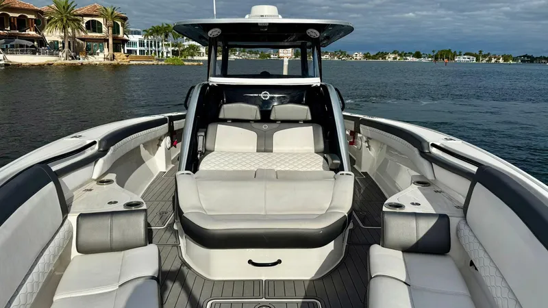 Slide: The Image of 2020 Fountain 43NX boat interior with luxurious seating on calm water. - 11