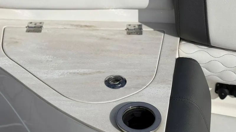 Slide: The Image of Interior detail of a 2020 Fountain 43NX boat, featuring a sleek cup holder and storage compartment. - 12