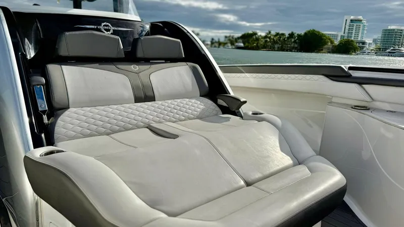 Slide: The Image of Luxurious seating on a 2020 Fountain 43NX boat with scenic waterfront view. - 17