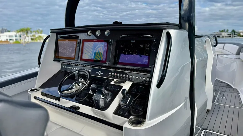 Slide: The Image of Cockpit of 2020 Fountain 43NX boat with advanced navigation displays and controls. - 20