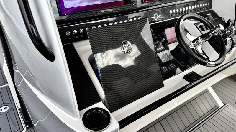 Slide: The Image of 2020 Fountain 43NX boat dashboard with steering wheel and control panel. - 27