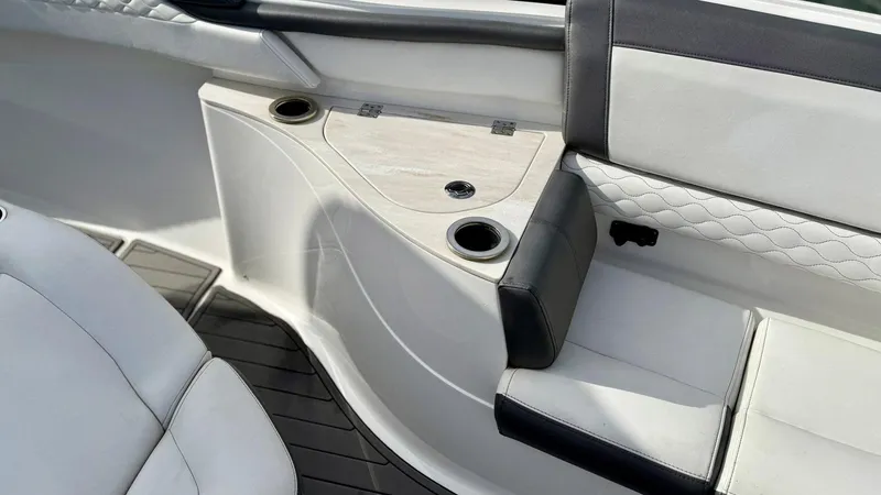 Slide: The Image of Interior seating of a 2020 Fountain 43NX boat with cup holders and cushioned seats. - 29