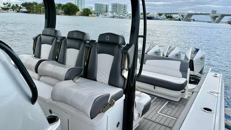 Slide: The Image of Luxury seating on a 2020 Fountain 43NX boat with scenic waterfront view. - 34
