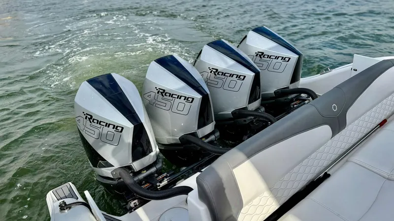 Slide: The Image of Four powerful outboard motors on a 2020 Fountain 43NX boat in water. - 39