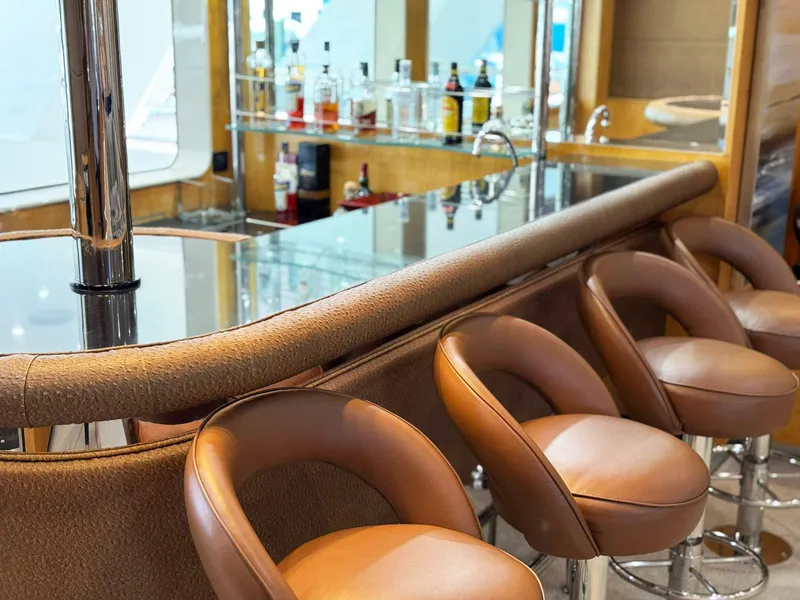 Slide: The Image of Luxurious yacht bar with leather stools, mirrored shelves, and assorted bottles on Cheoy Lee 145 Global Series. - 41