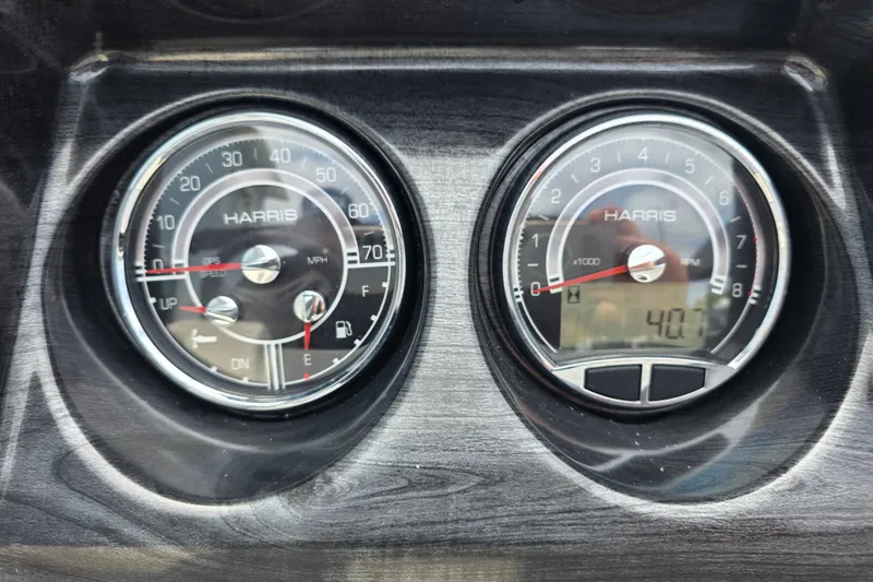 Slide: The Image of Dashboard gauges of a 2021 Harris Cruiser 230, displaying speed and RPM. - 12