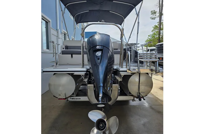 Slide: The Image of 2021 Harris Cruiser 230 pontoon boat with outboard motor and canopy. - 2
