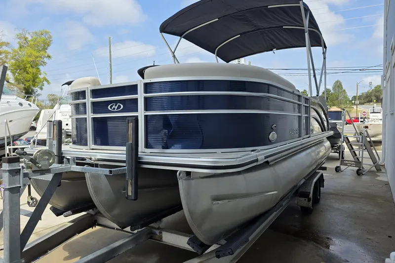 Slide: The Image of 2021 Harris Cruiser 230 pontoon boat on trailer, featuring blue and silver design. - 5