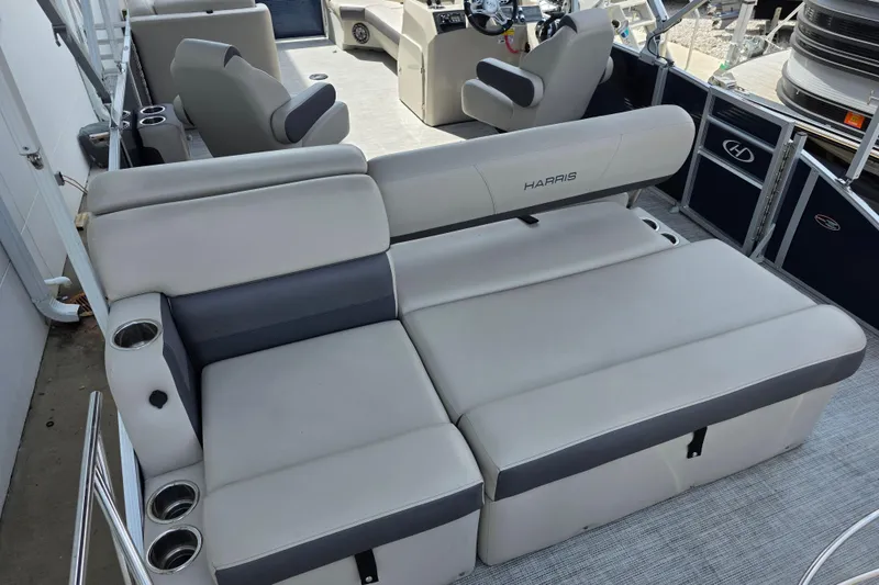Slide: The Image of 2021 Harris Cruiser 230 boat interior with spacious seating and cup holders. - 7