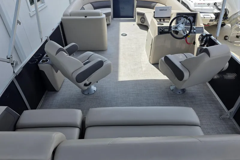 Slide: The Image of Interior of 2021 Harris Cruiser 230 pontoon boat with plush seating and steering console. - 9