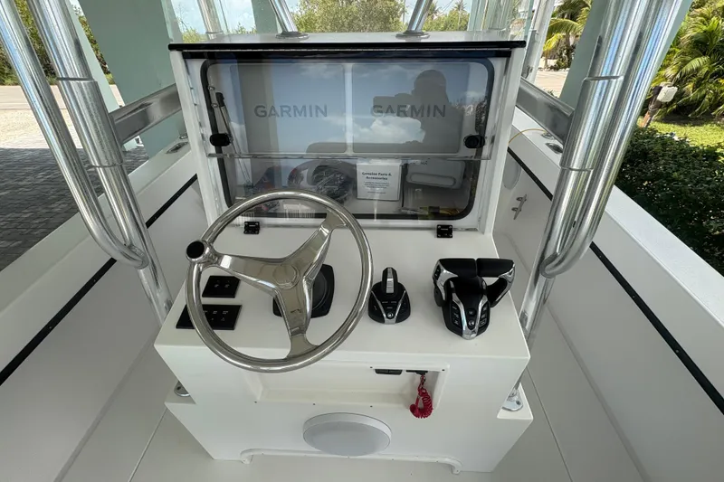 Slide: The Image of Helm of 2025 Whitewater 28 boat with Garmin navigation system and controls. - 10