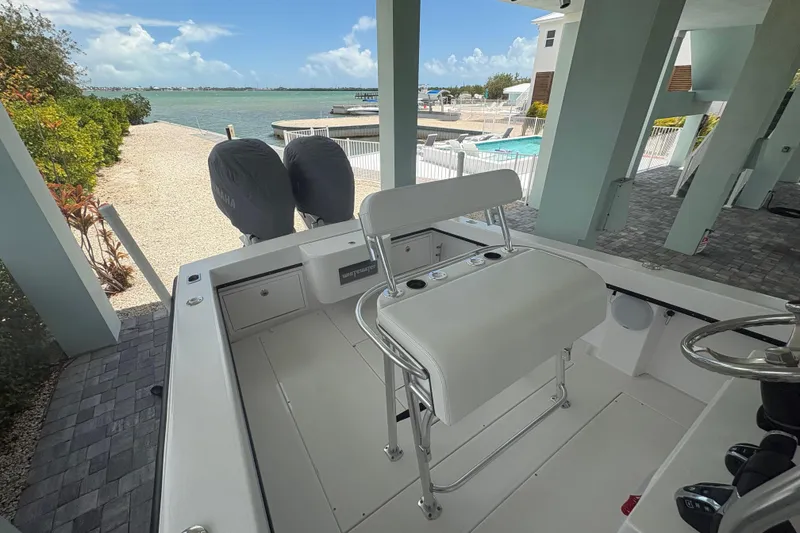 Slide: The Image of 2025 Whitewater 28 boat docked near a scenic waterfront with clear skies. - 12