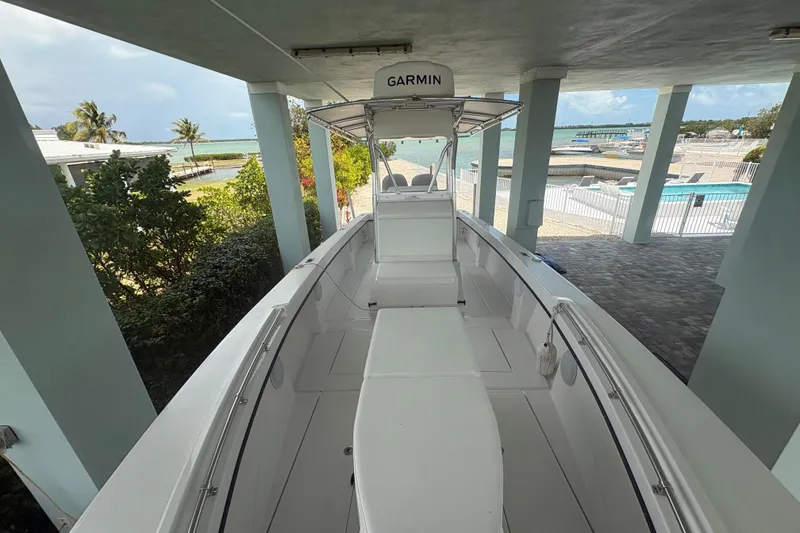 Slide: The Image of 2025 Whitewater 28 boat docked under a canopy near a tropical beach. - 16