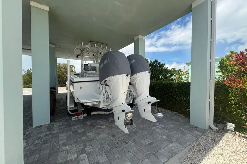 Slide: The Image of 2025 Whitewater 28 boat with Yamaha engines parked under a shelter. - 3