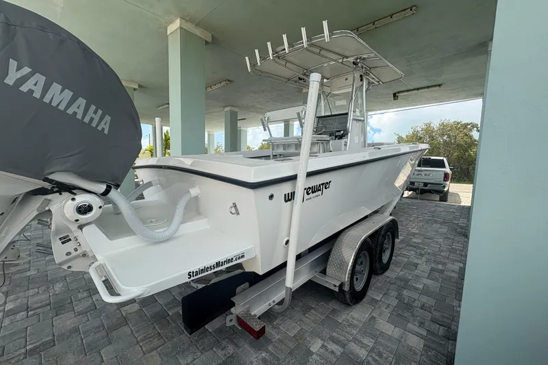 Slide: The Image of 2025 Whitewater 28 boat on trailer with Yamaha engine, parked under a shelter. - 4