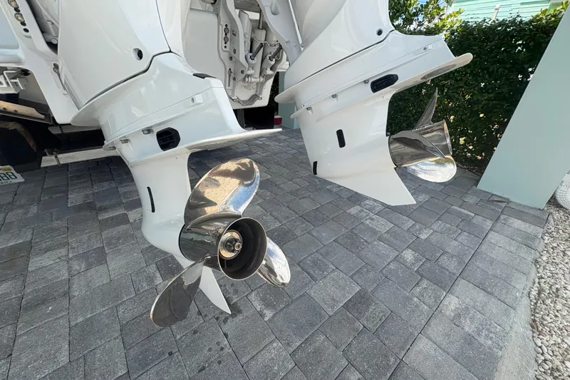 Slide: The Image of Twin propellers of a 2025 Whitewater 28 boat on a paved surface. - 5