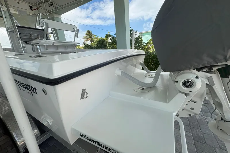 Slide: The Image of 2025 Whitewater 28 boat with stainless marine features, docked under a clear sky. - 7