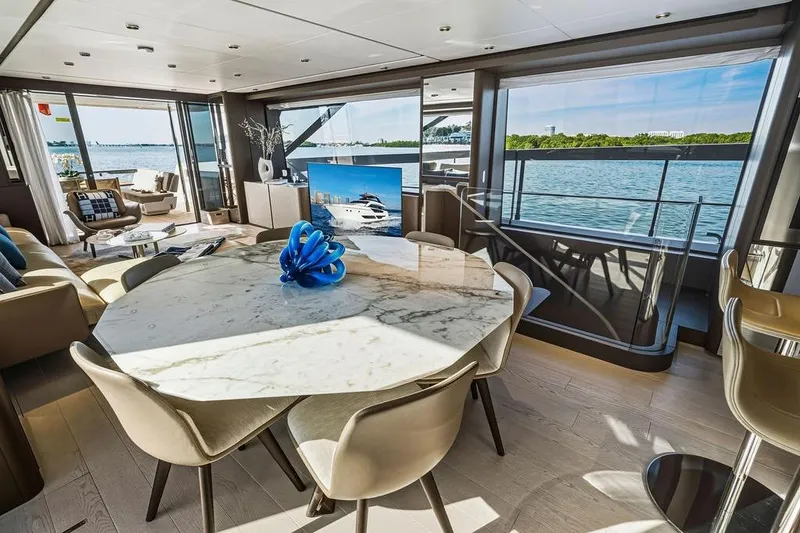 Slide: The Image of Luxurious interior of 2023 Ferretti Yachts 860 with elegant dining area and scenic ocean views. - 12