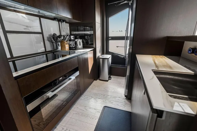 Slide: The Image of Luxurious kitchen interior of 2023 Ferretti Yachts 860, featuring modern appliances and sleek design. - 16