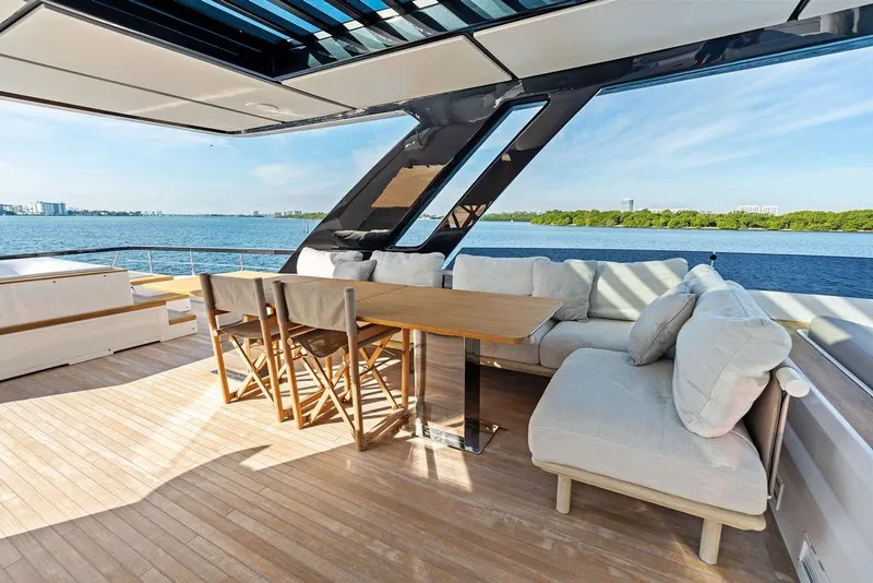 Slide: The Image of Luxurious 2023 Ferretti Yachts 860 deck with elegant seating and stunning ocean view. - 27