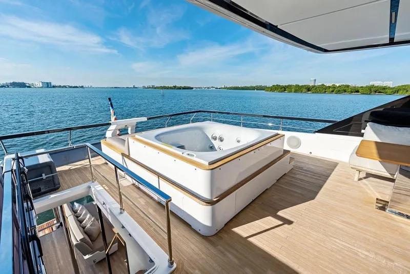 Slide: The Image of Luxurious 2023 Ferretti Yachts 860 with jacuzzi on deck, overlooking serene ocean view. - 31