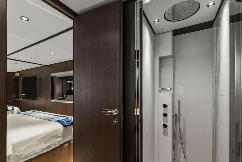Slide: The Image of Luxurious interior of 2023 Ferretti Yachts 860, featuring a modern bedroom and sleek shower area. - 52