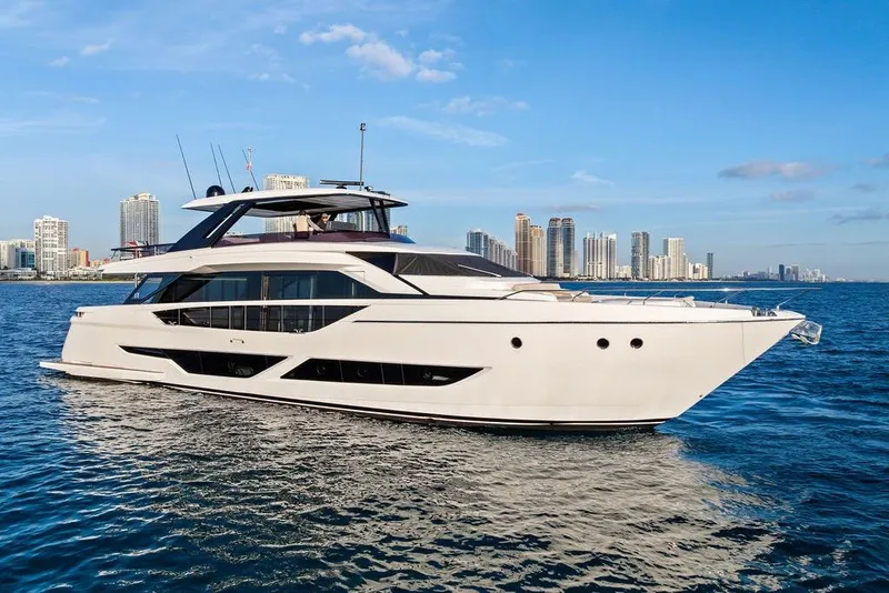 Slide: The Image of Luxury 2023 Ferretti Yachts 860 cruising near city skyline on a sunny day. - 60