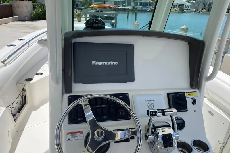 Slide: The Image of Boston Whaler 280 Outrage 2009 helm with Raymarine display and steering wheel. - 10