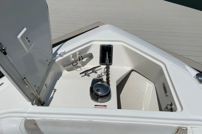 Slide: The Image of Open anchor locker on 2009 Boston Whaler 280 Outrage boat, showing chain and storage. - 17