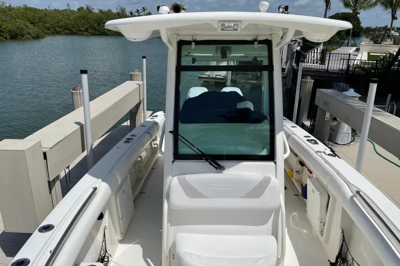 Slide: The Image of 2009 Boston Whaler 280 Outrage boat docked by a serene waterfront. - 22