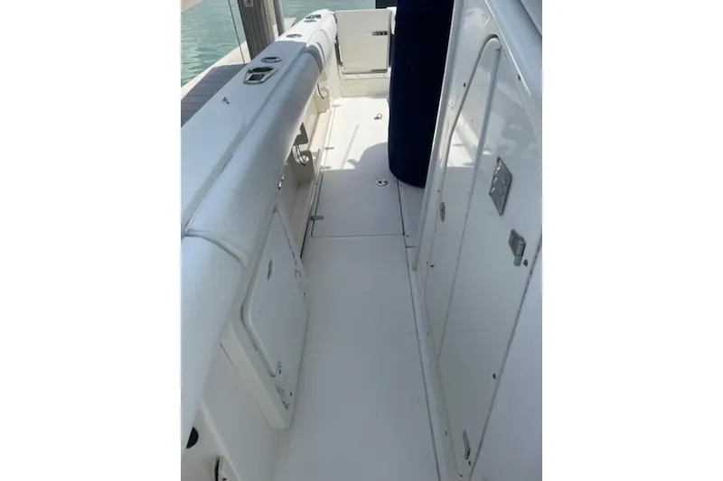 Slide: The Image of 2009 Boston Whaler 280 Outrage boat interior with white seating and storage compartments. - 25