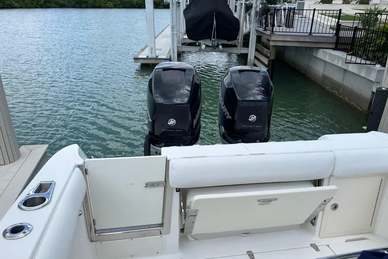Slide: The Image of 2009 Boston Whaler 280 Outrage with twin Mercury outboard engines docked by the water. - 26