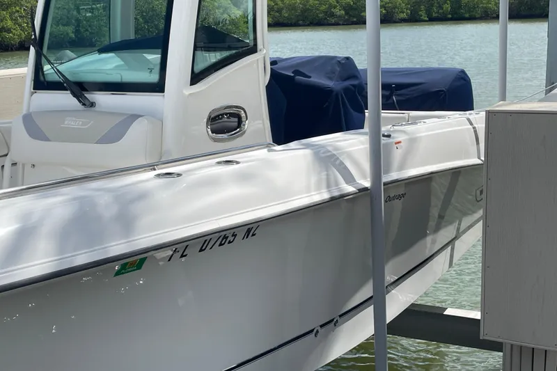 Slide: The Image of 2009 Boston Whaler 280 Outrage boat docked by the water. - 29